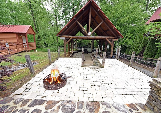 view of patio / terrace with a gazebo and a fire pit
