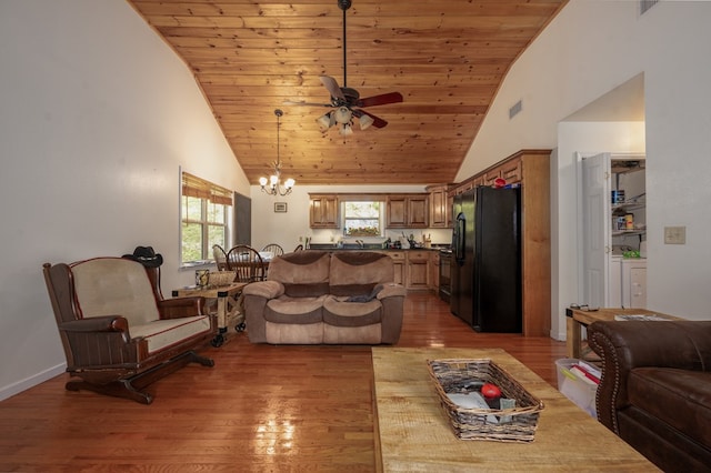 living room with wood ceiling, wood-type flooring, ceiling fan with notable chandelier, and high vaulted ceiling