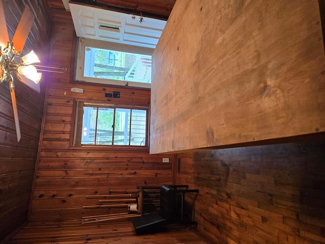 bathroom with wooden walls and wood finished floors