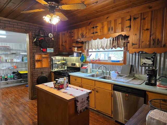 kitchen with stainless steel appliances, a ceiling fan, a sink, and brick wall
