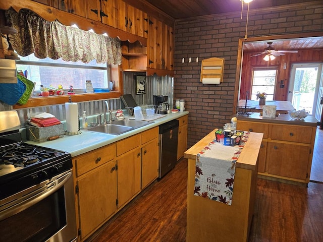kitchen with a center island, a sink, brick wall, stainless steel appliances, and dark wood-style floors