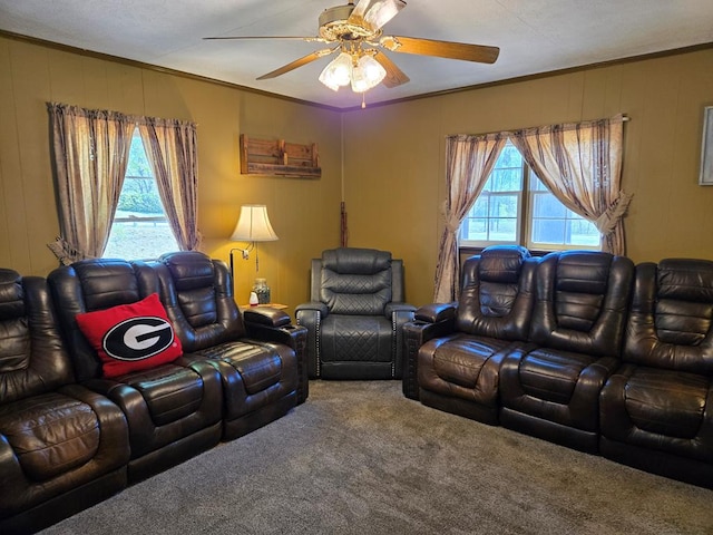 carpeted living room featuring ceiling fan and ornamental molding