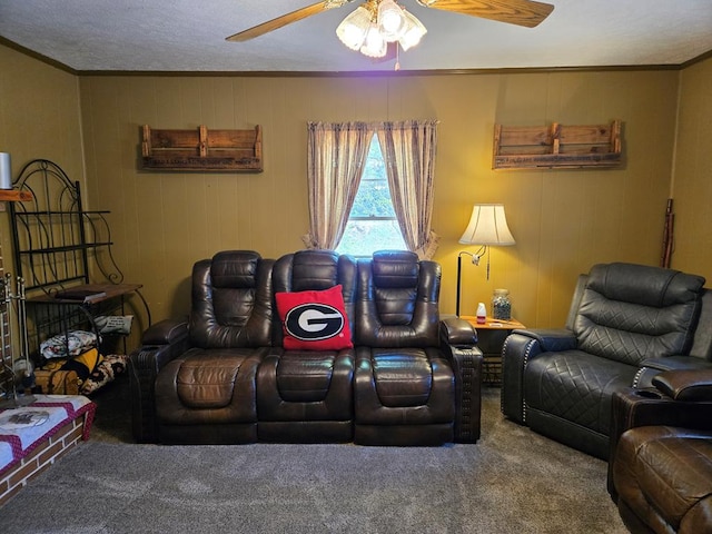 carpeted living area with ornamental molding and a ceiling fan
