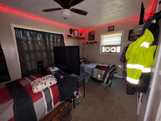 bedroom with carpet flooring, ceiling fan, and a textured ceiling