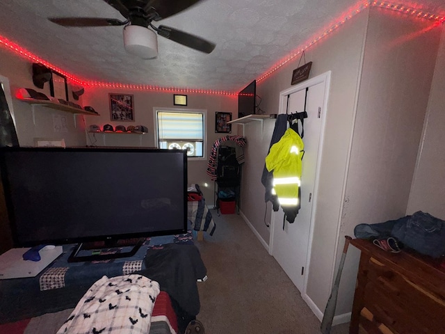 carpeted bedroom featuring a textured ceiling and ceiling fan