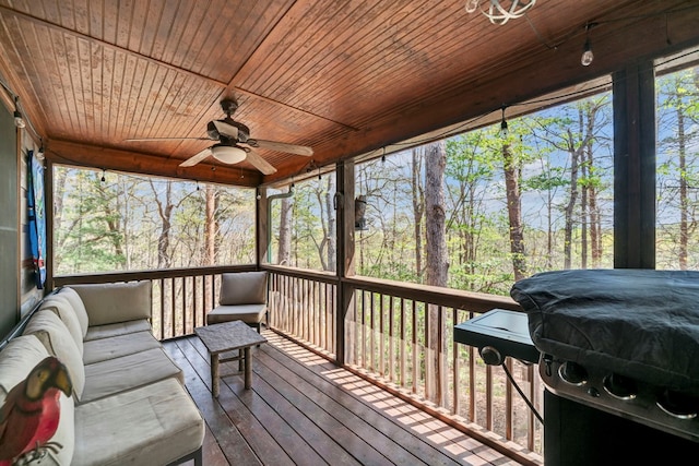 sunroom featuring wood ceiling and ceiling fan