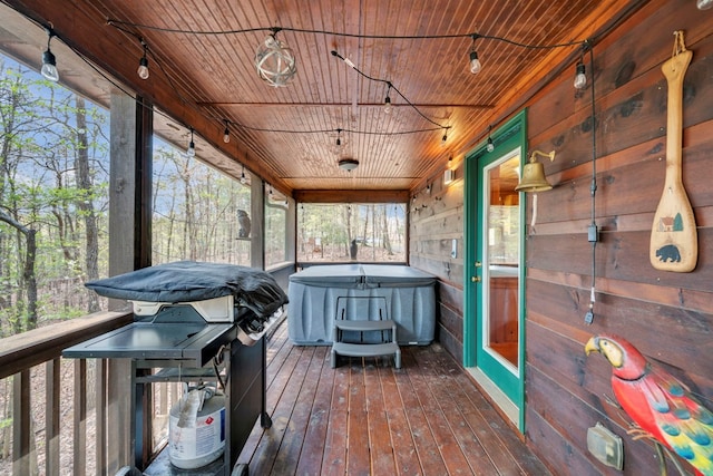 wooden terrace featuring a hot tub and area for grilling