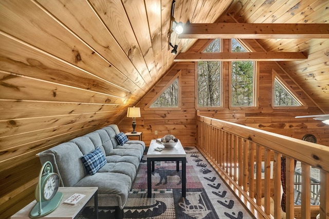 additional living space with wooden walls, lofted ceiling with beams, and wooden ceiling