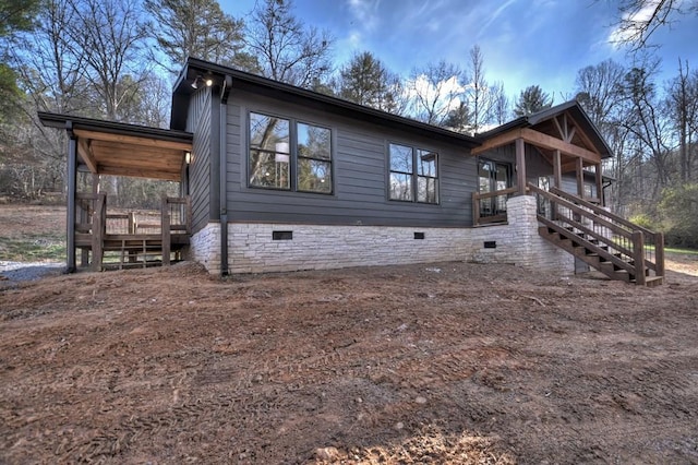 exterior space with stairs, a porch, and crawl space