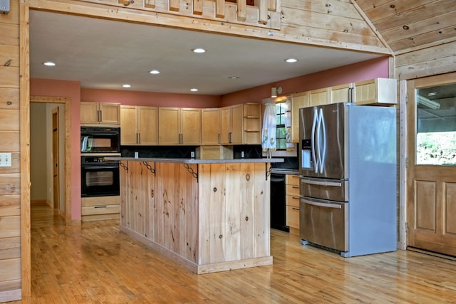 kitchen featuring black appliances, light wood-style flooring, light brown cabinets, and a healthy amount of sunlight