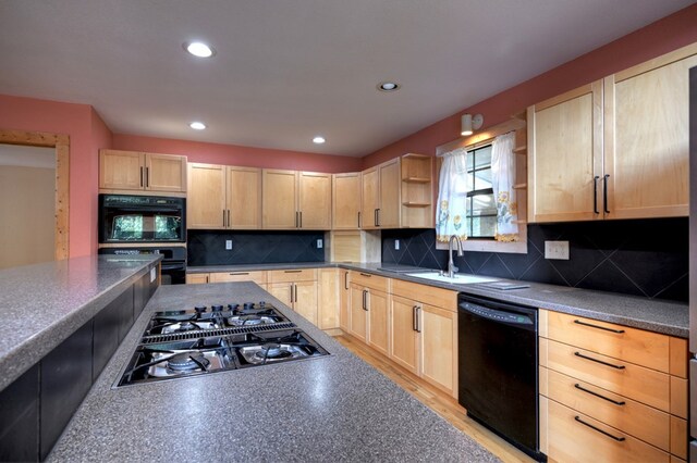 kitchen featuring light hardwood / wood-style flooring, a kitchen breakfast bar, wooden walls, backsplash, and black appliances