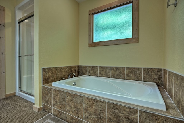 full bathroom featuring a bath and a stall shower