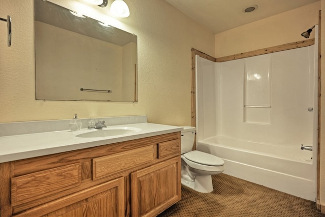 full bath featuring vanity, tile patterned floors, toilet, a textured wall, and shower / bathtub combination