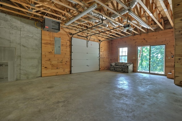 garage featuring electric panel and a garage door opener
