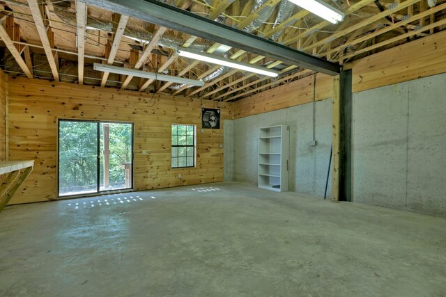 basement featuring wooden walls