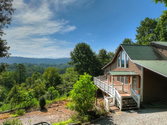 exterior space with a wooded view