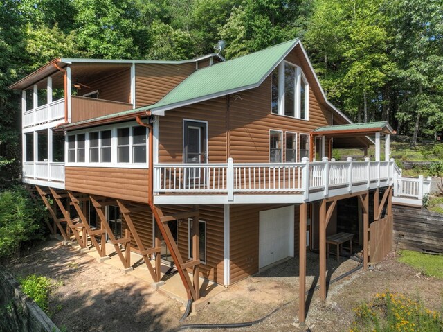 rear view of house featuring a deck