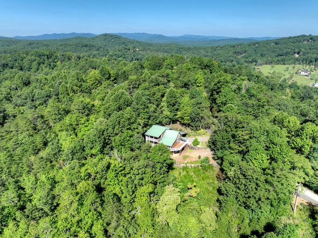 drone / aerial view with a mountain view and a wooded view