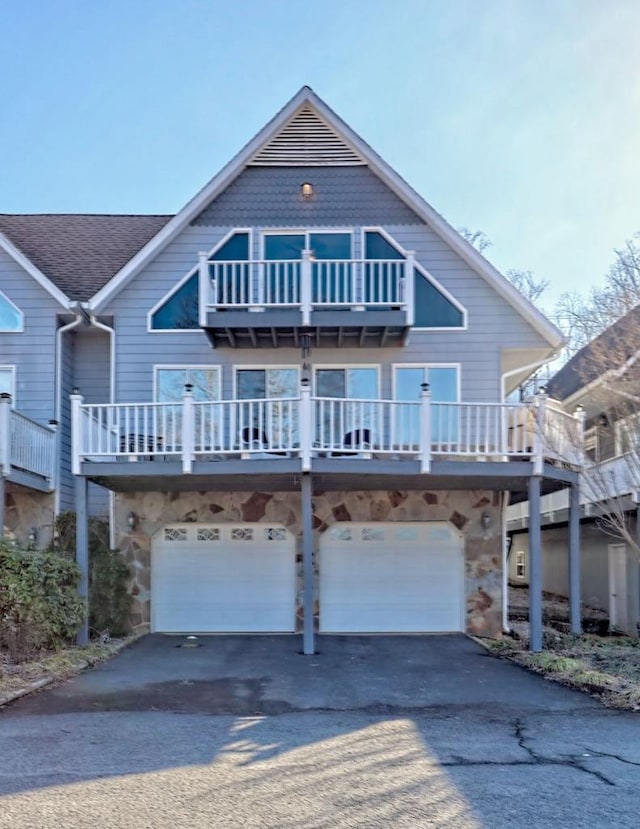 view of front of home with a balcony and a garage