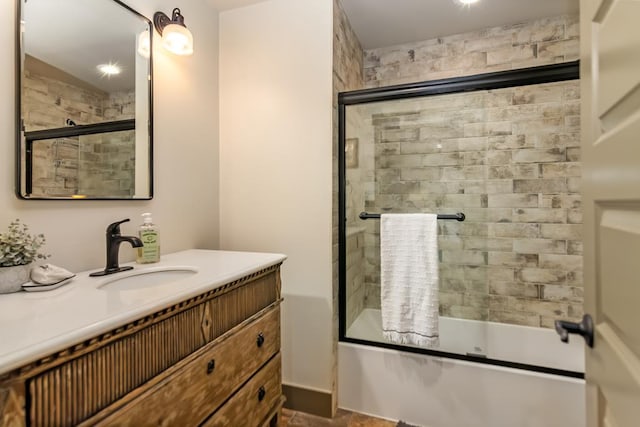 full bath with combined bath / shower with glass door and vanity