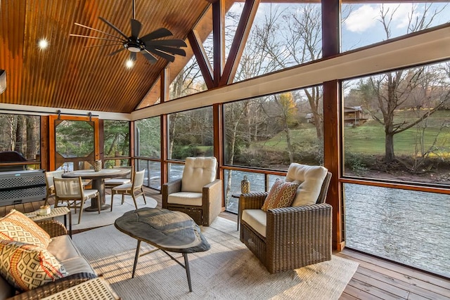 sunroom featuring a wealth of natural light, a ceiling fan, and vaulted ceiling