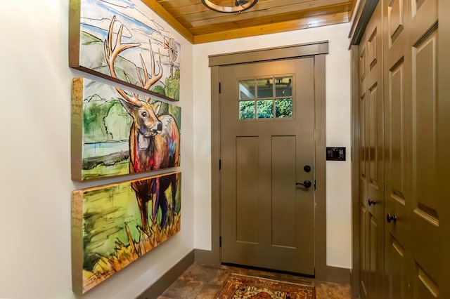 entryway featuring wooden ceiling and baseboards