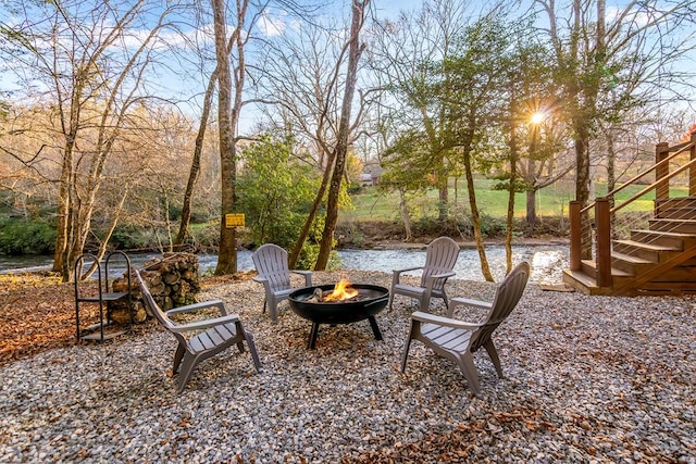 view of yard featuring a fire pit and stairs