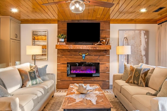 living room featuring visible vents, recessed lighting, wooden ceiling, a glass covered fireplace, and a ceiling fan