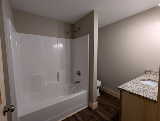 full bathroom with hardwood / wood-style flooring, vanity, shower / bath combination, and toilet