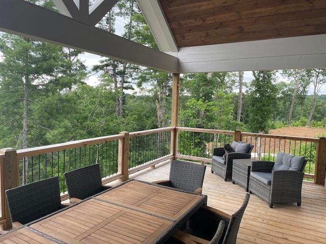 wooden terrace featuring an outdoor living space