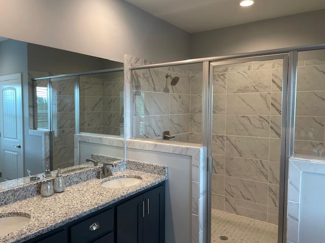 bathroom with vanity and a shower with shower door