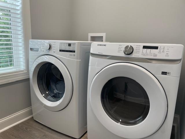 washroom featuring dark hardwood / wood-style flooring and washer and dryer