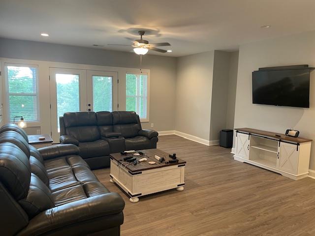 living room featuring dark hardwood / wood-style flooring, french doors, and ceiling fan