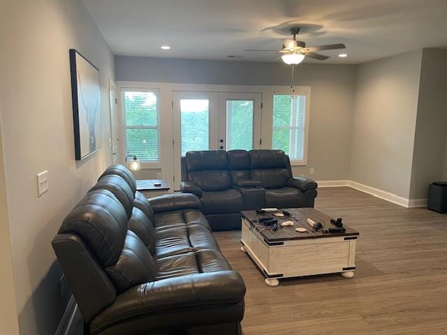 living room featuring french doors, ceiling fan, a healthy amount of sunlight, and hardwood / wood-style floors