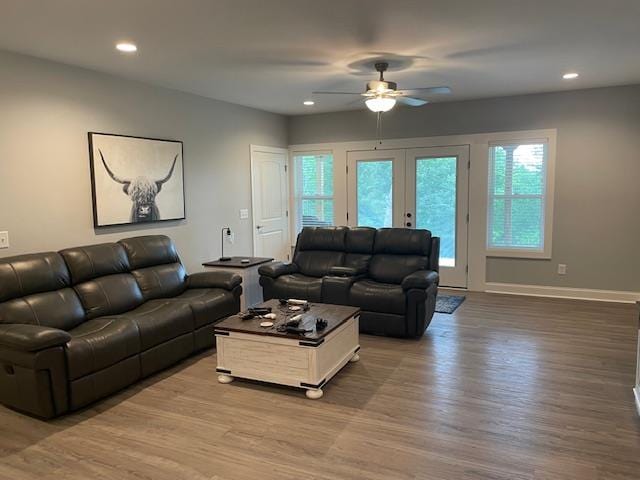 living room featuring hardwood / wood-style floors, french doors, and ceiling fan