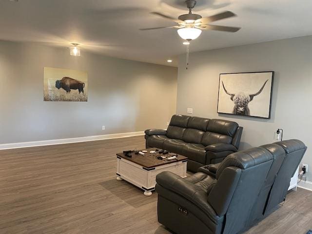 living room with dark hardwood / wood-style flooring and ceiling fan