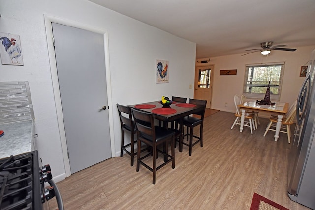 dining area with ceiling fan and light hardwood / wood-style floors