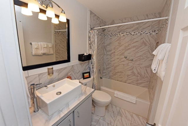 full bathroom with shower / bath combo, vanity, toilet, and tile walls