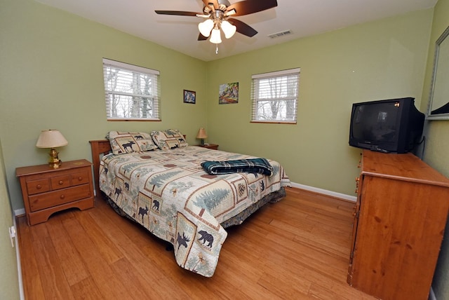 bedroom with light hardwood / wood-style floors and ceiling fan