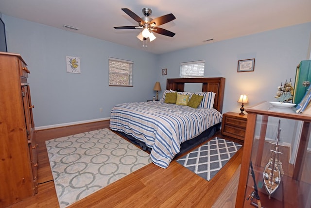 bedroom with ceiling fan and light hardwood / wood-style flooring