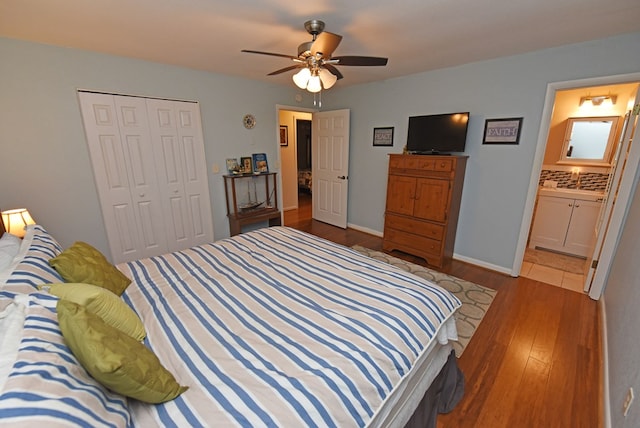 bedroom featuring hardwood / wood-style floors, ensuite bathroom, a closet, and ceiling fan