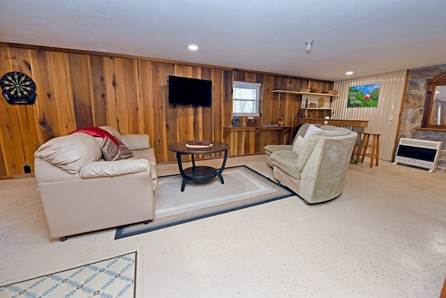 living room with heating unit and wooden walls