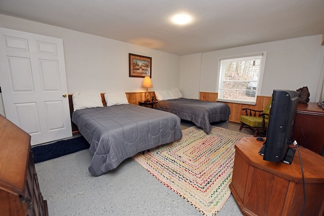 bedroom featuring wood walls