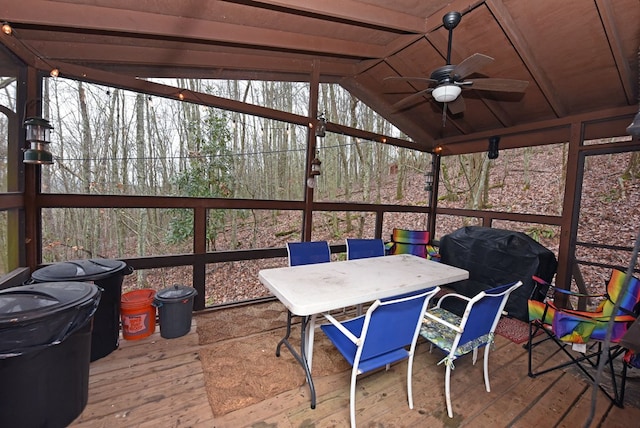 sunroom / solarium with vaulted ceiling with beams, ceiling fan, and wooden ceiling