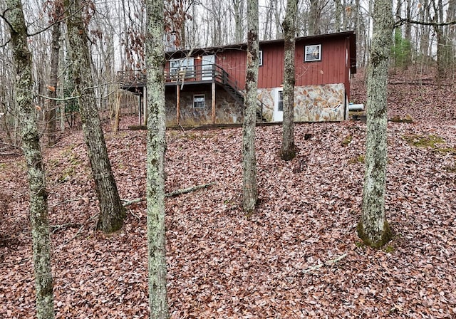 rear view of property featuring a balcony