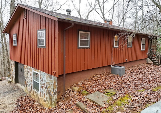 view of home's exterior with a garage and central air condition unit