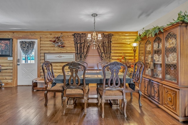 32 Mountain Meadows Dr, Hayesville, NC 28904 - dining area with log walls, a chandelier, and wood-type flooring