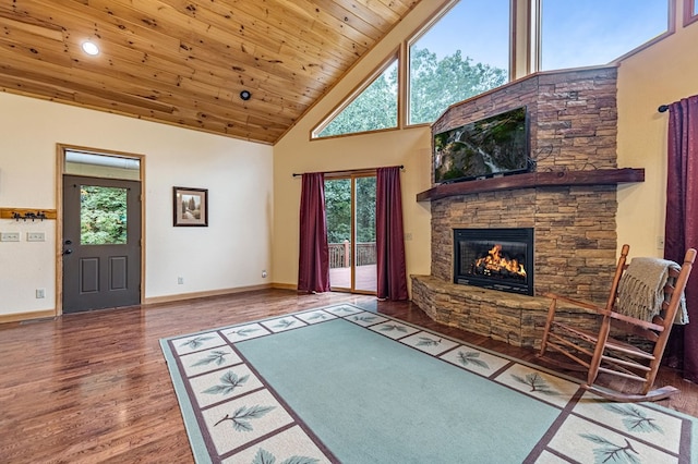 living room with a stone fireplace, wood finished floors, high vaulted ceiling, wooden ceiling, and baseboards