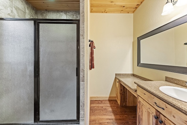 full bath featuring wooden ceiling, a stall shower, wood finished floors, and vanity