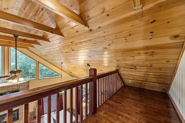 corridor with vaulted ceiling with beams, wood finished floors, and wood ceiling